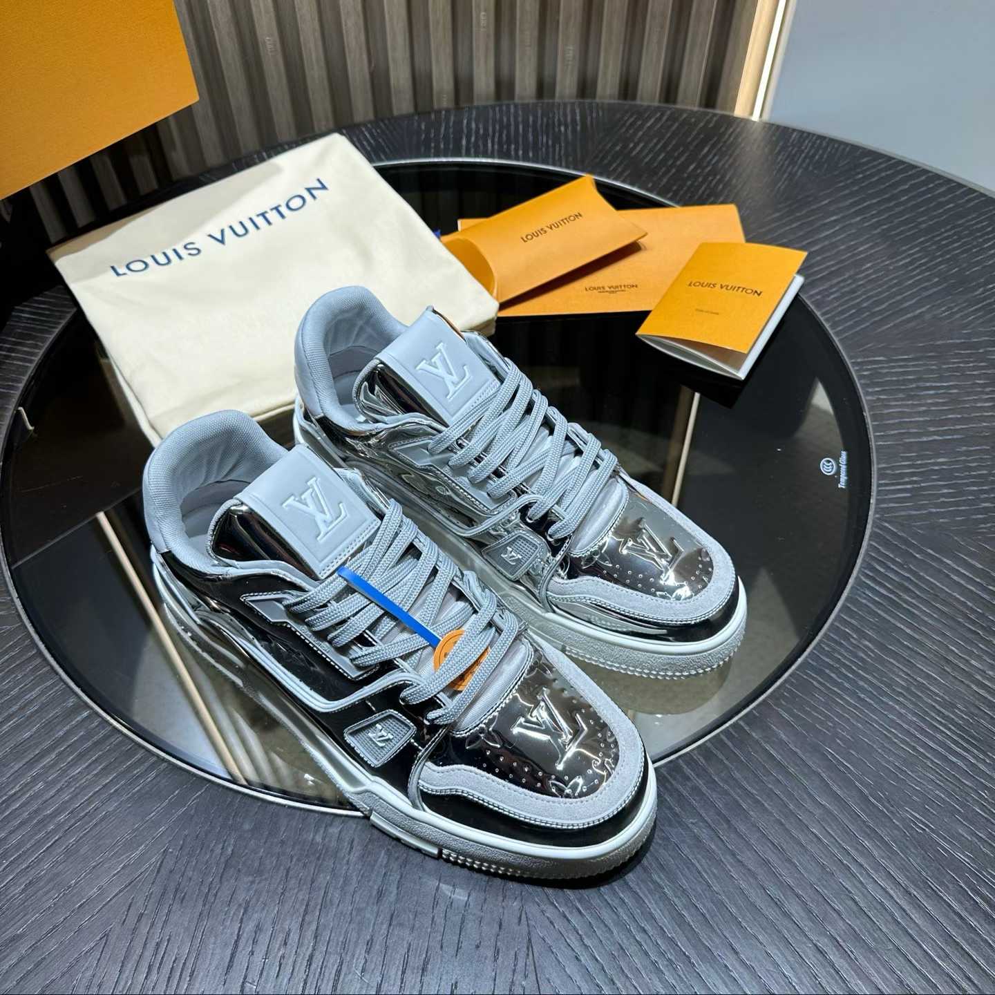 LV Trainer sneaker in a silver/grey and black colorway with a metallic finish