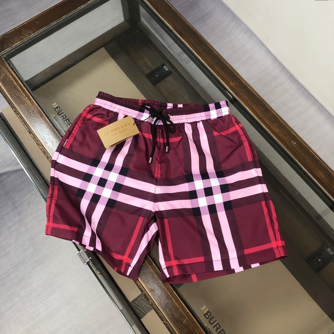 Burberry check swim shorts in red and pink.