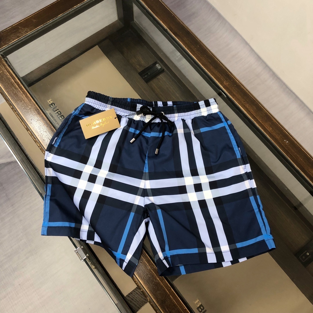 Burberry check swim shorts in a blue, black, and white plaid pattern.
