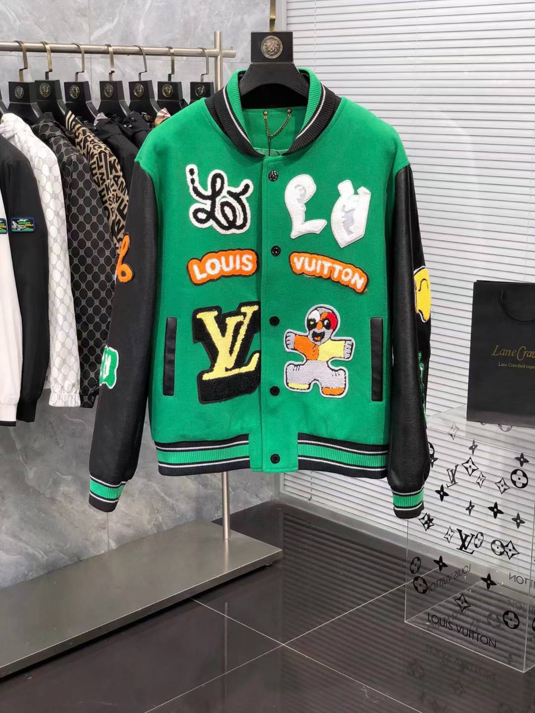 LV green varsity jacket with leather sleeves and assorted patches