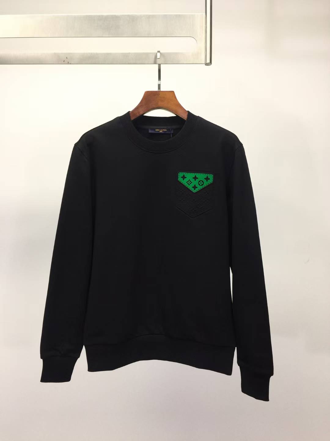 LV sweatshirt with a green embroidered logo.