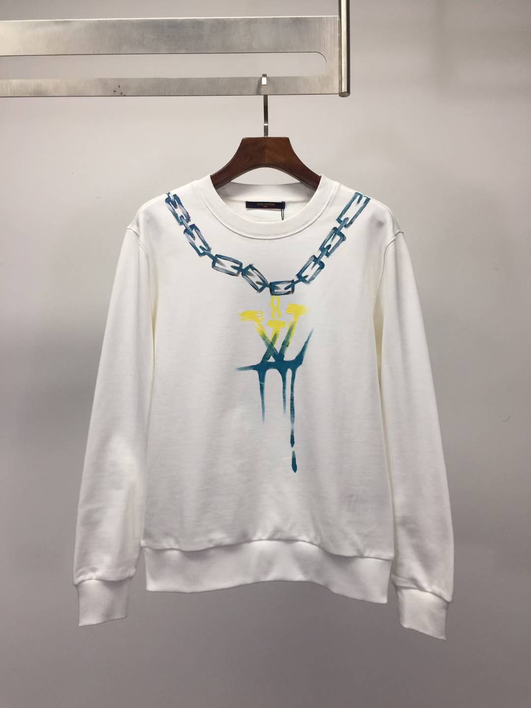 LV white sweatshirt with a chain and dripping logo graphic