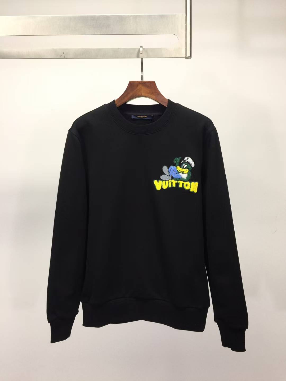 LV black cotton sweatshirt with an embroidered cartoon graphic from the Fall-Winter 2025 collection