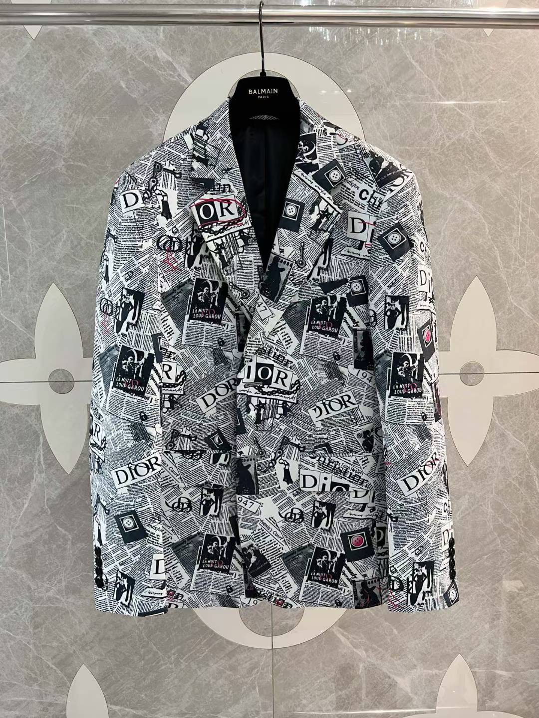 christian dior men's casual blazer with a newspaper print pattern the Dior logo