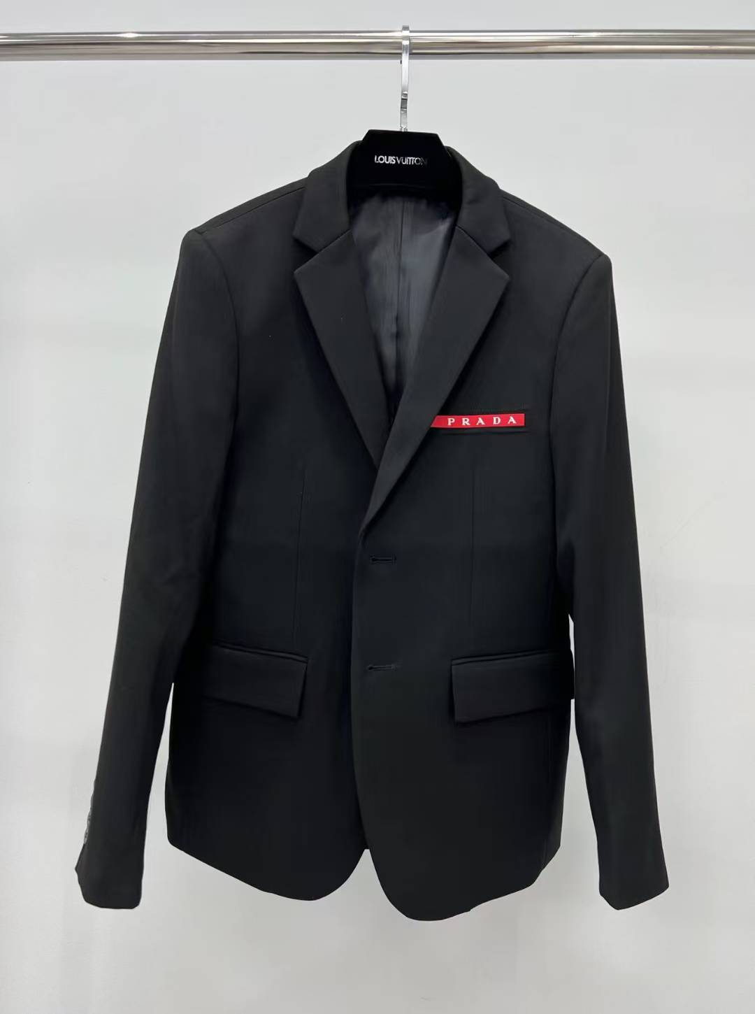 prada black single-breasted blazer with a red Prada logo patch