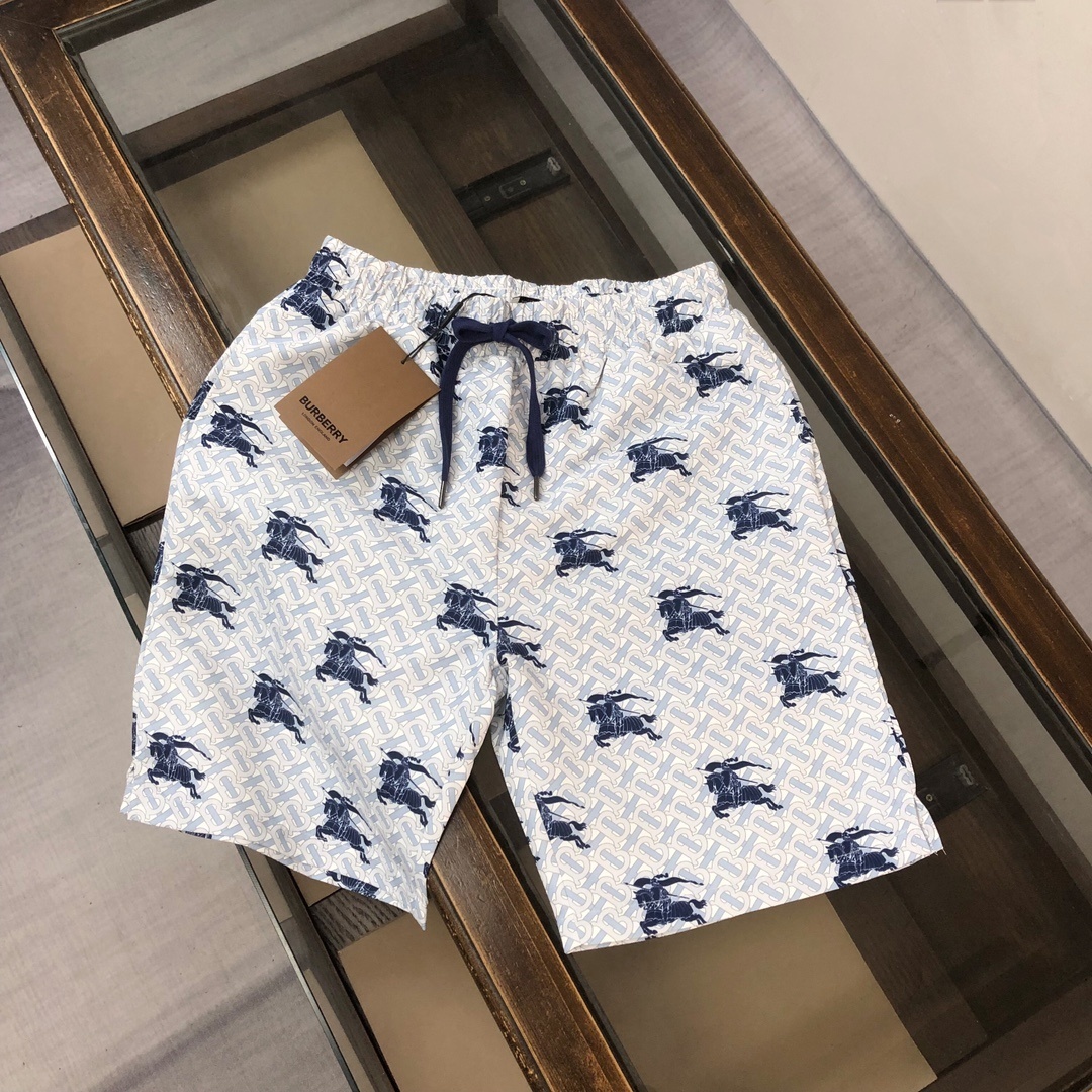 Burberry EKD TB-monogram swim shorts in blue and white silk.