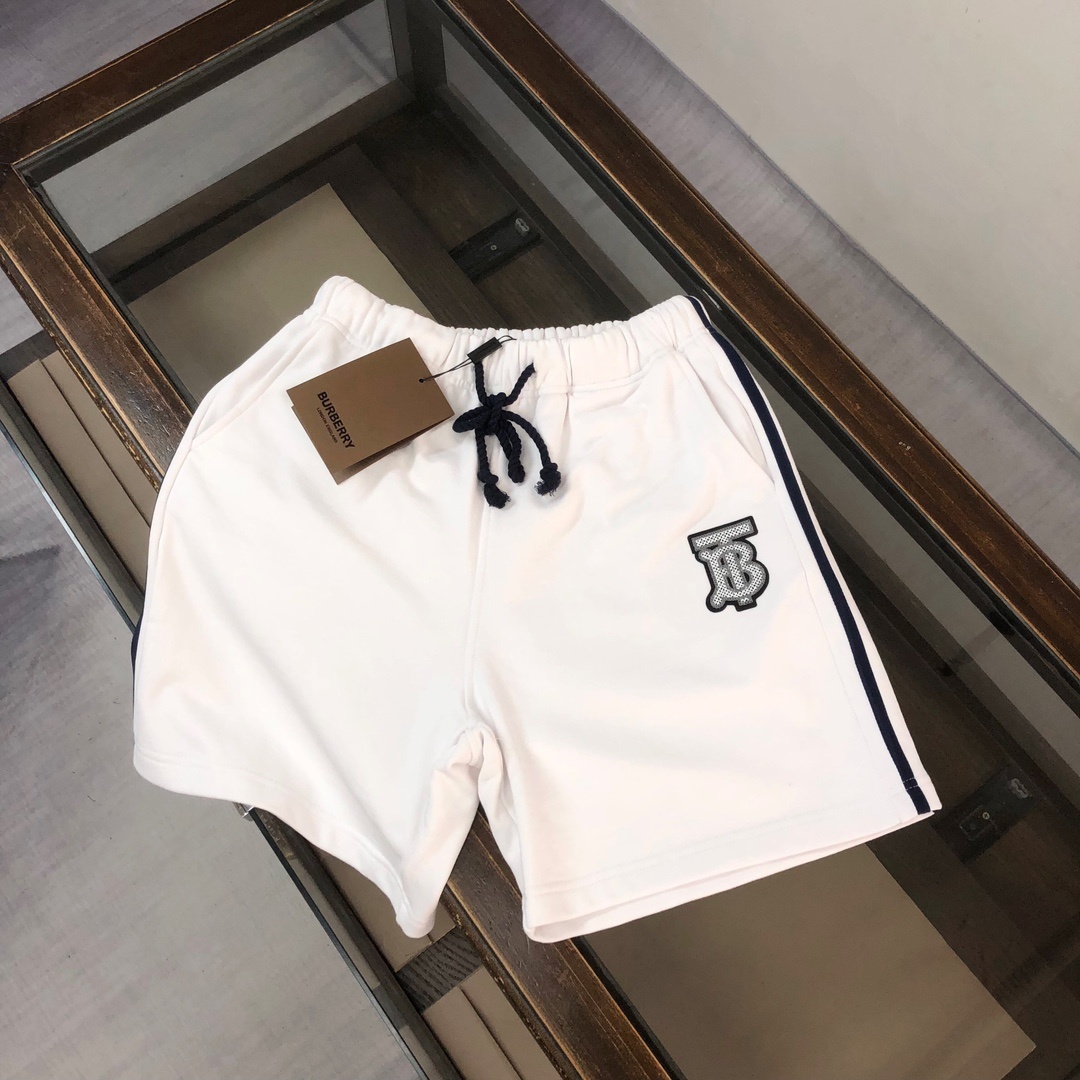 Burberry logo-print cotton shorts in white with a black side stripe and an elasticated drawstring waistband.