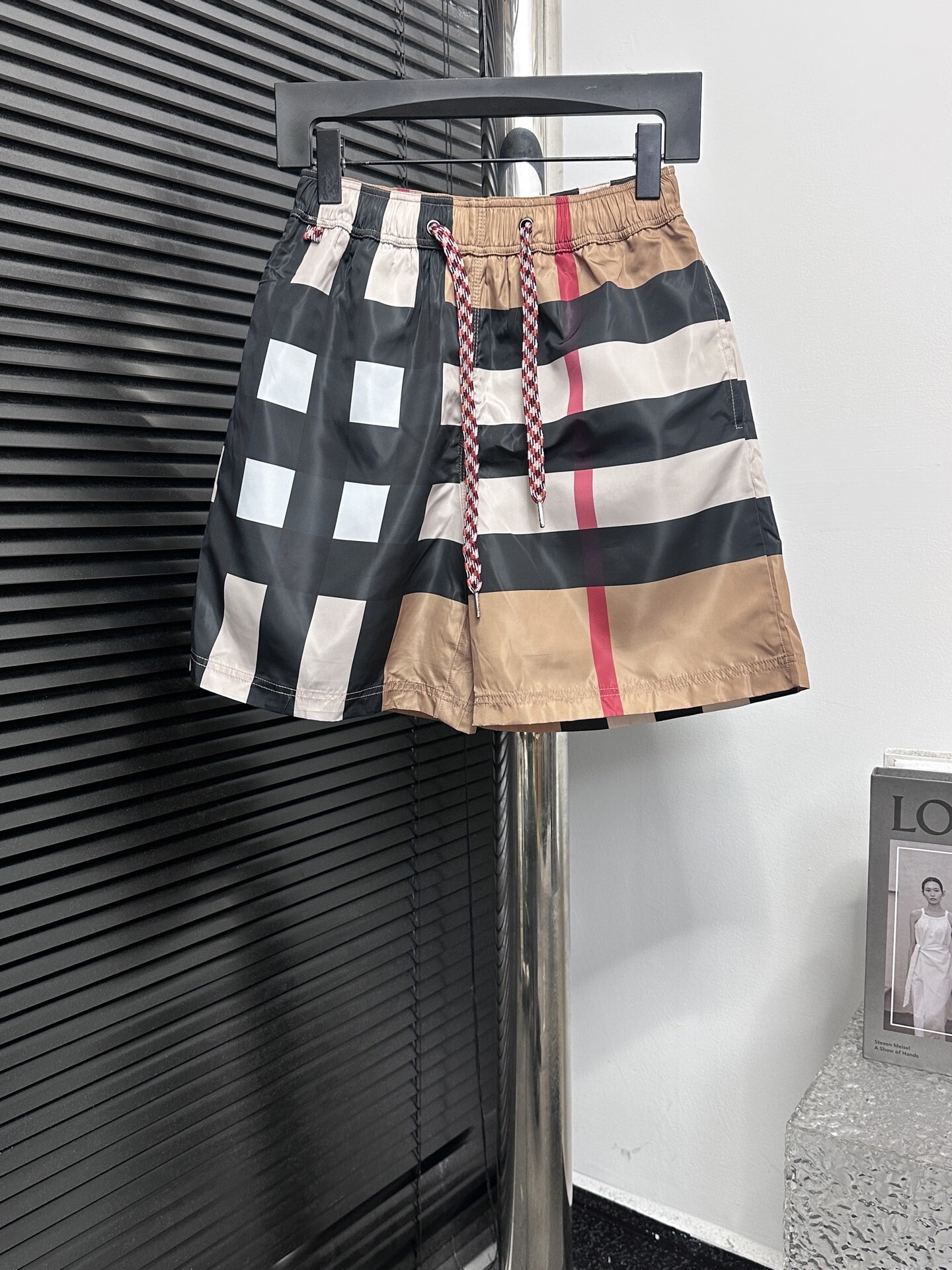 Burberry men's check swim shorts in beige, black, and red