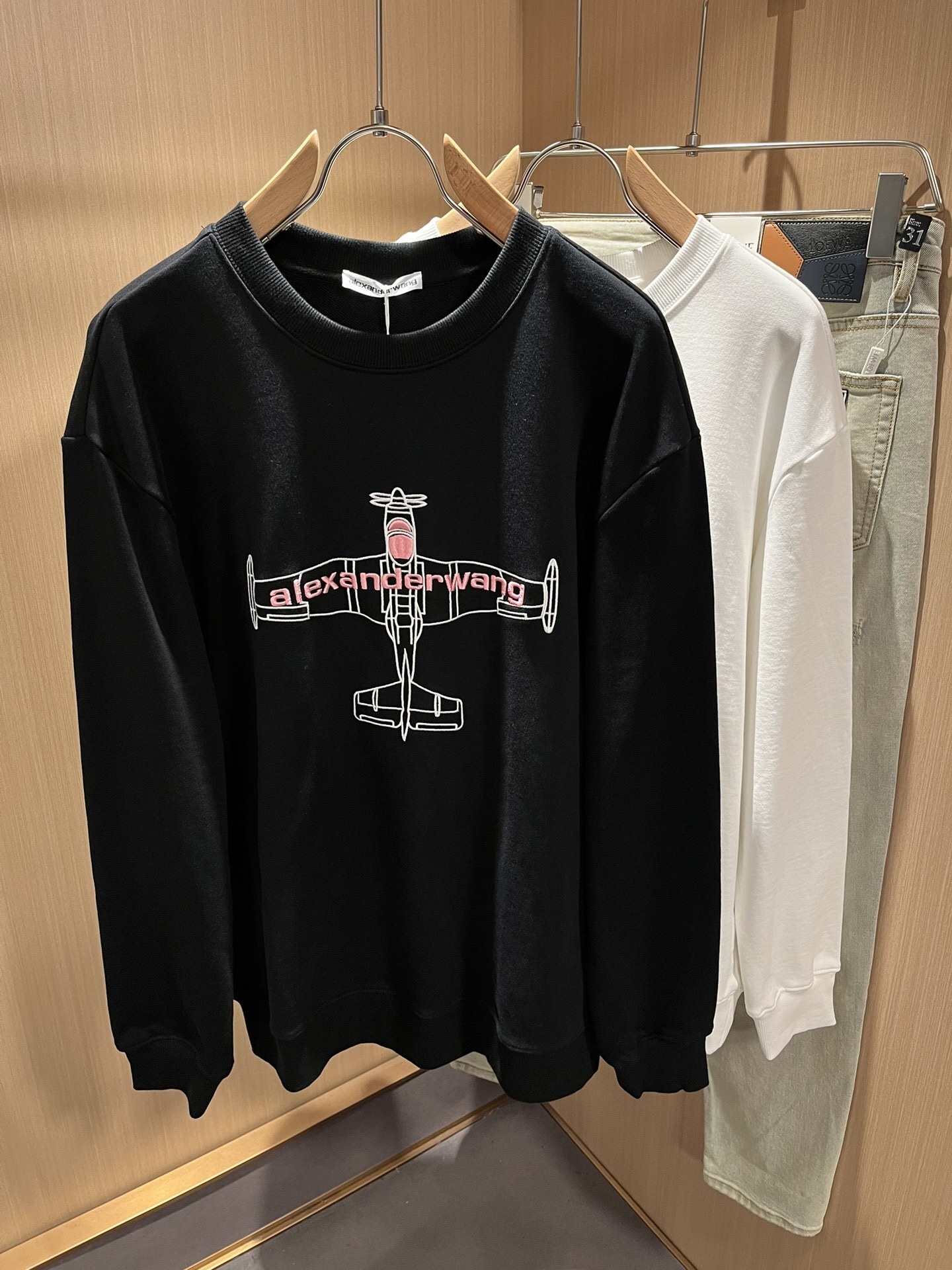 Alexander Wang black crewneck sweatshirt with a graphic of an airplane.