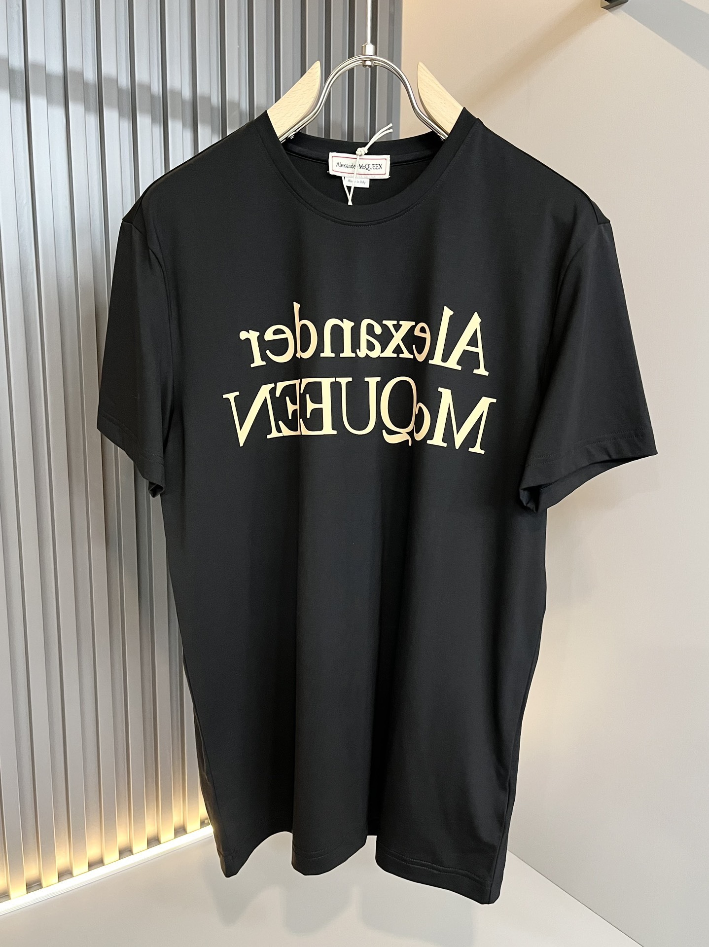 Alexander McQueen men's reflected logo cotton t-shirt in black and gold.