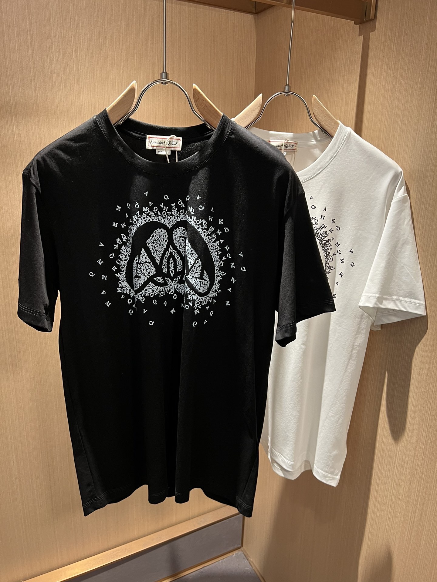 Alexander McQueen Exploded Charm T-Shirt available in black and white cotton.