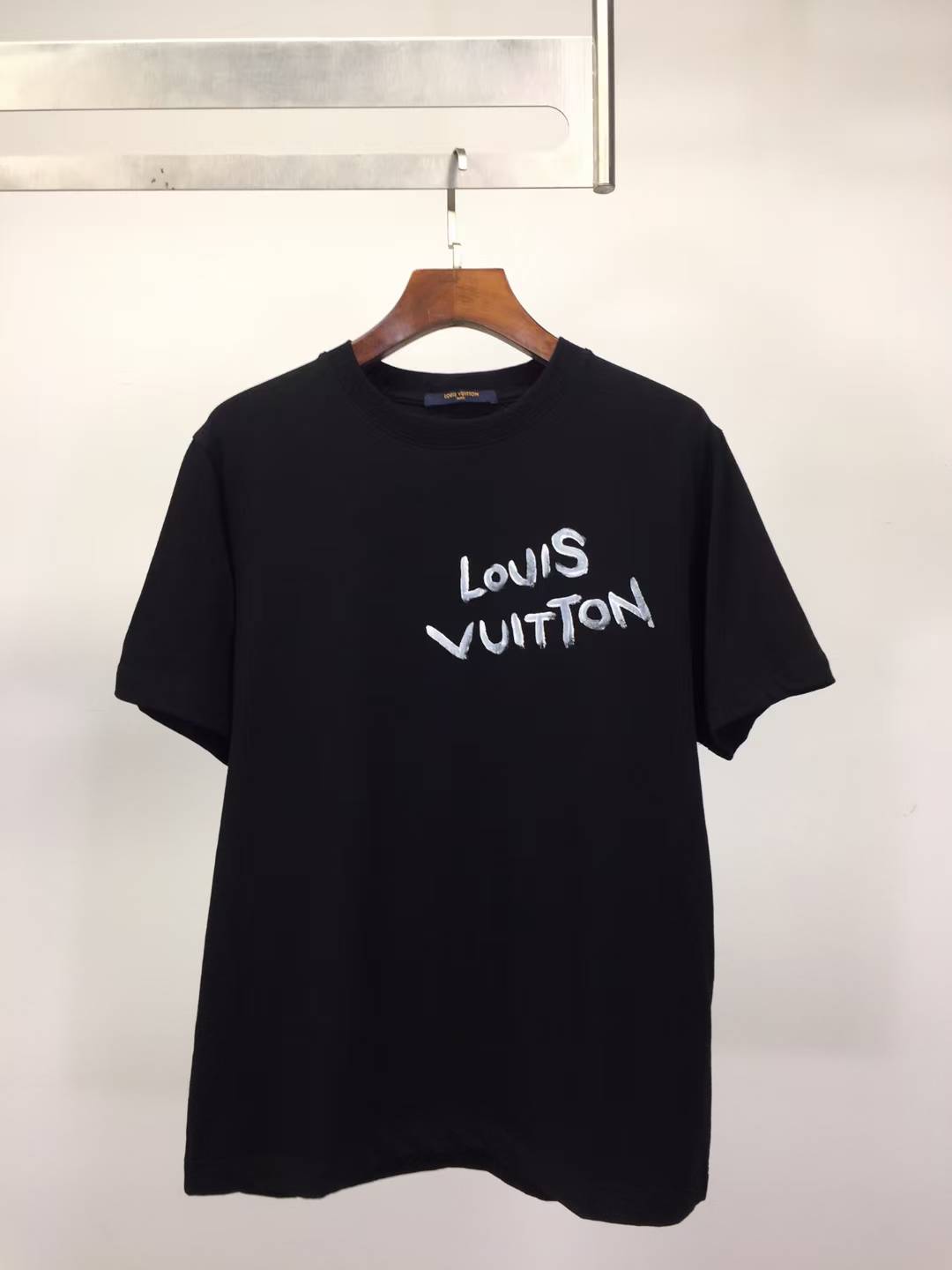 LV black T-shirt with a white handwritten-style logo print on the chest