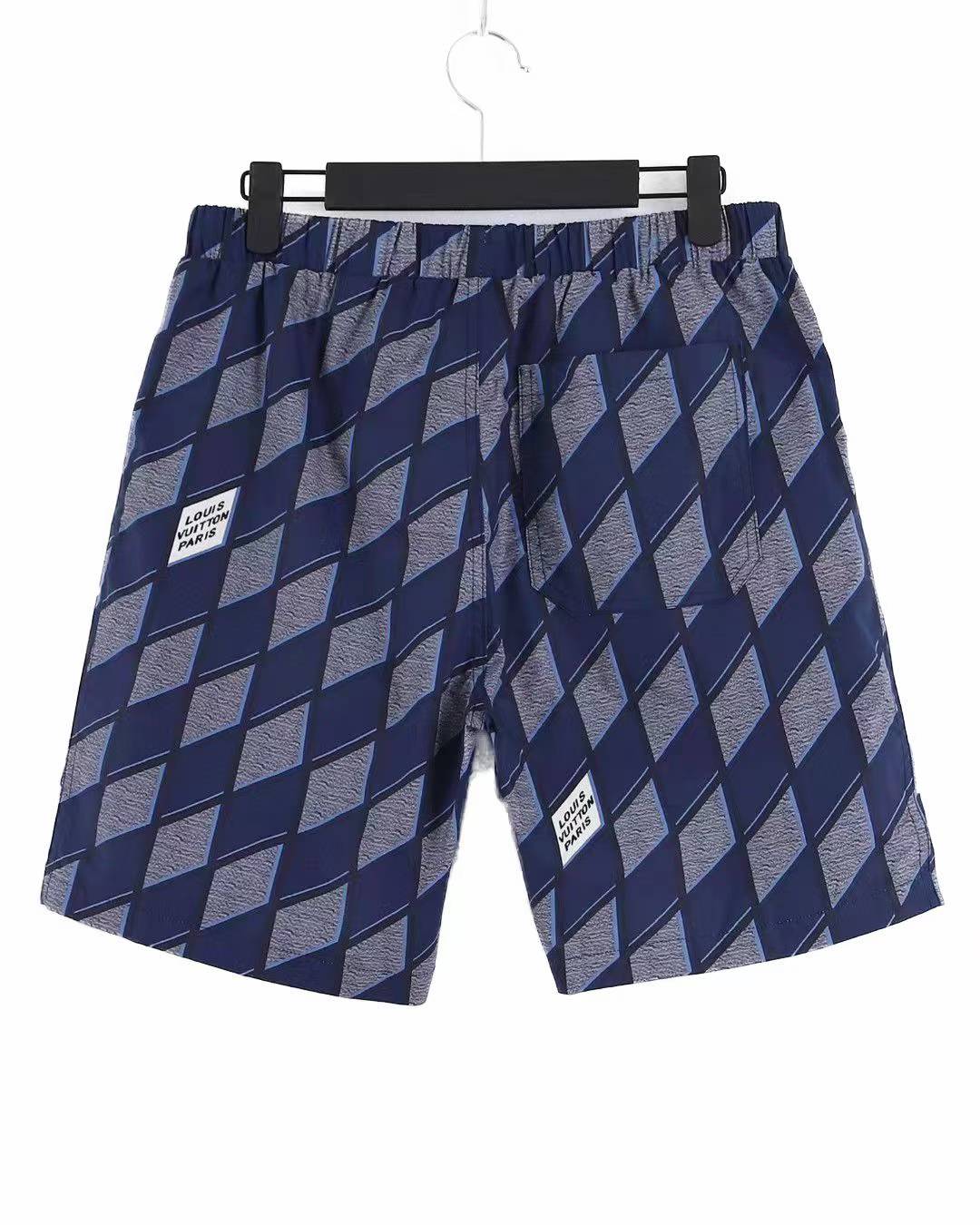 LV blue and grey patterned swim shorts.