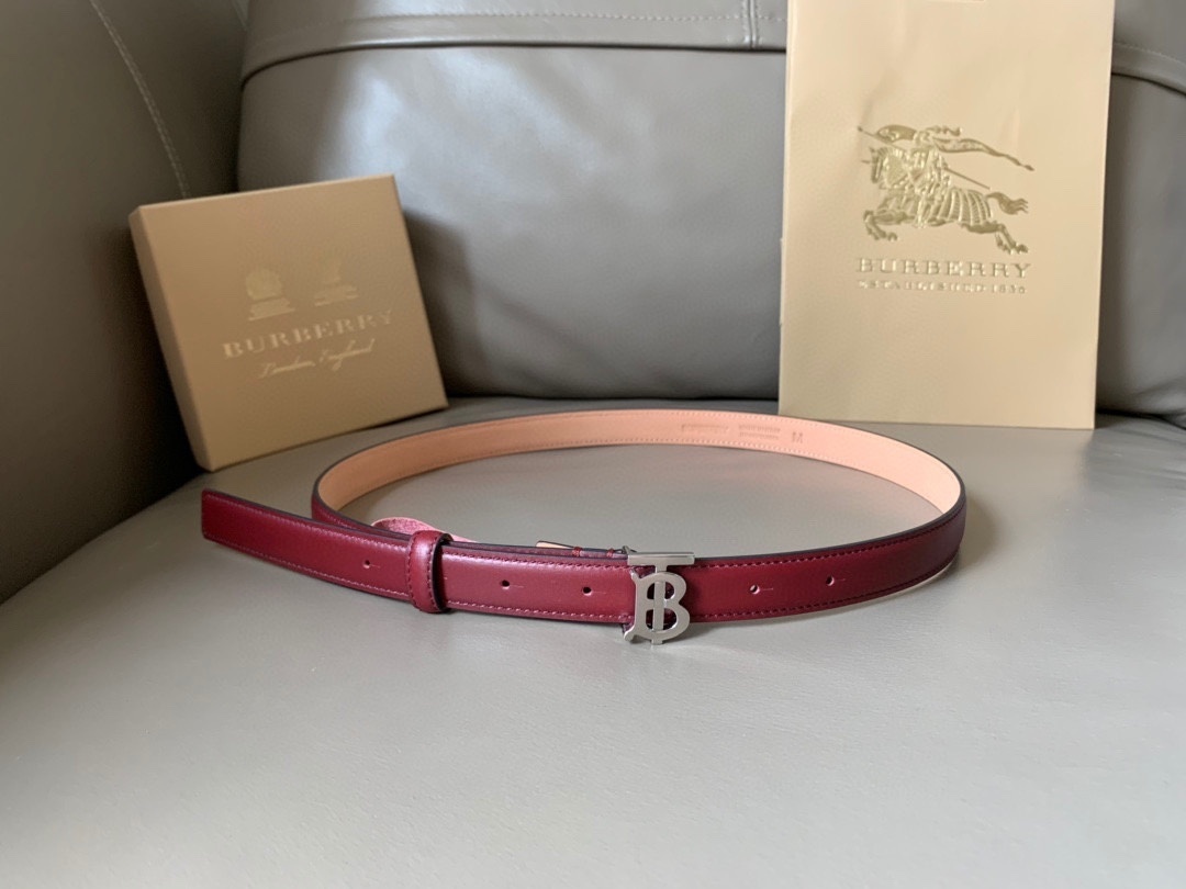 Burberry leather belt with a silver-tone TB monogram buckle in a reddish-brown or burgundy color.