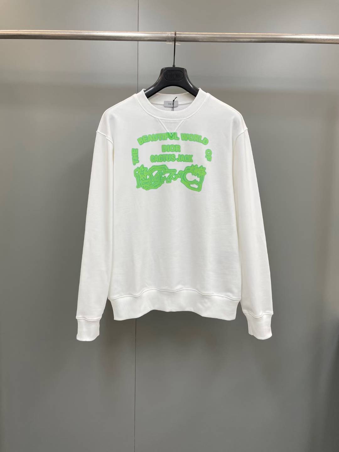 Dior x Cactus Jack sweatshirt in white with a green logo.