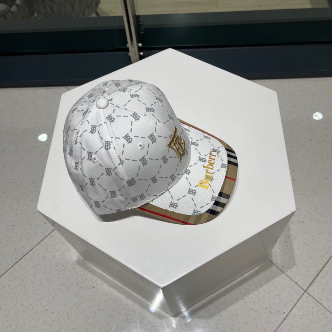 Burberry baseball cap with a "TB" monogram pattern and a classic check under the brim.