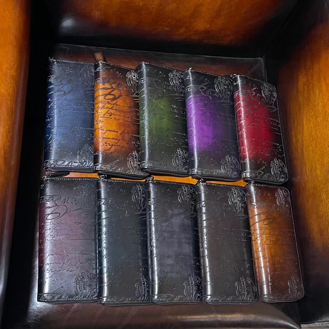 Berluti Santal Calligraphy leather long wallets featuring a Neo Scritto design and an antique coloring patina