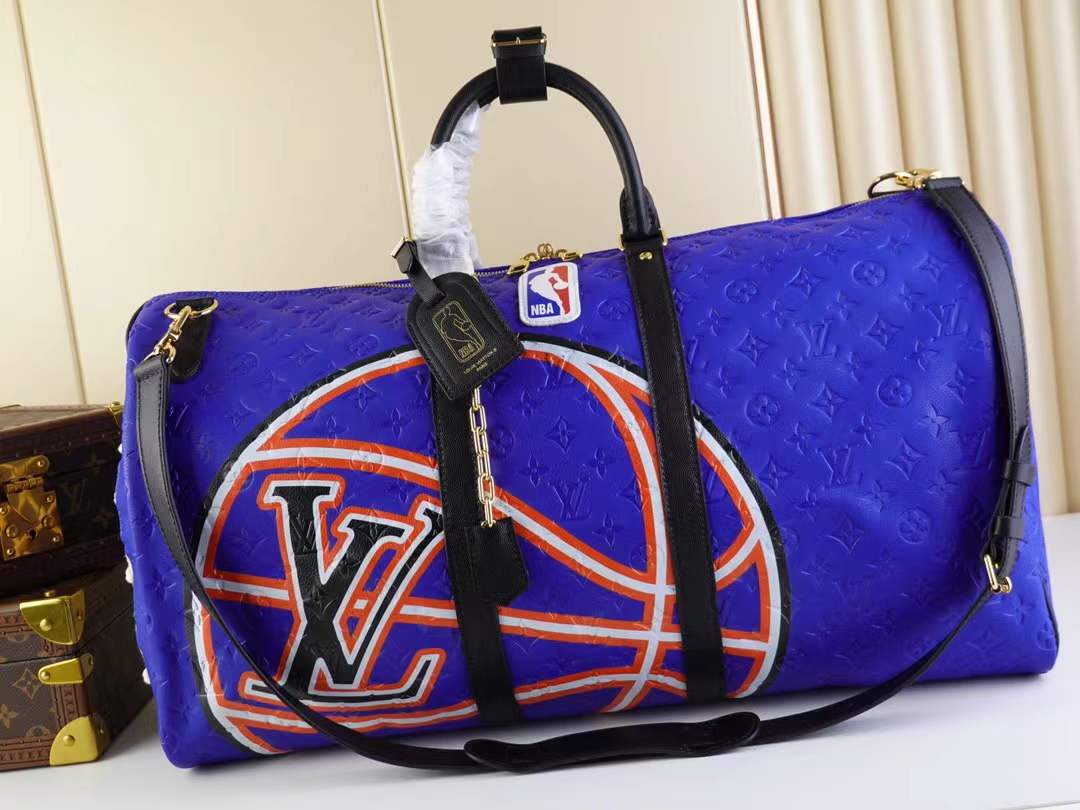 LV x NBA Keepall 55 Bandoulière travel bag in blue Taurillon leather with an embossed Monogram motif.