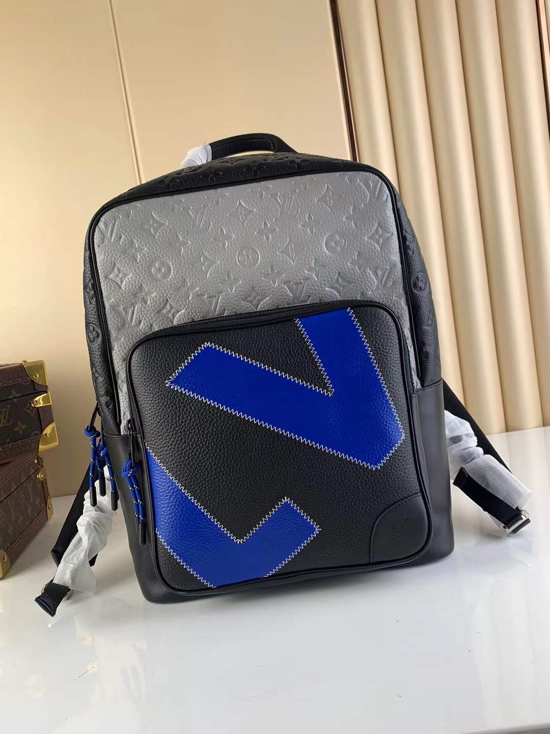 LV Dean Backpack made from Monogram-embossed and plain Taurillon leather in black and blue.