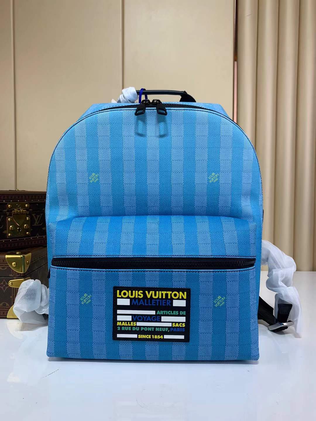 LV Discovery Backpack in the limited edition blue gradient Damier Stripes coated canvas.