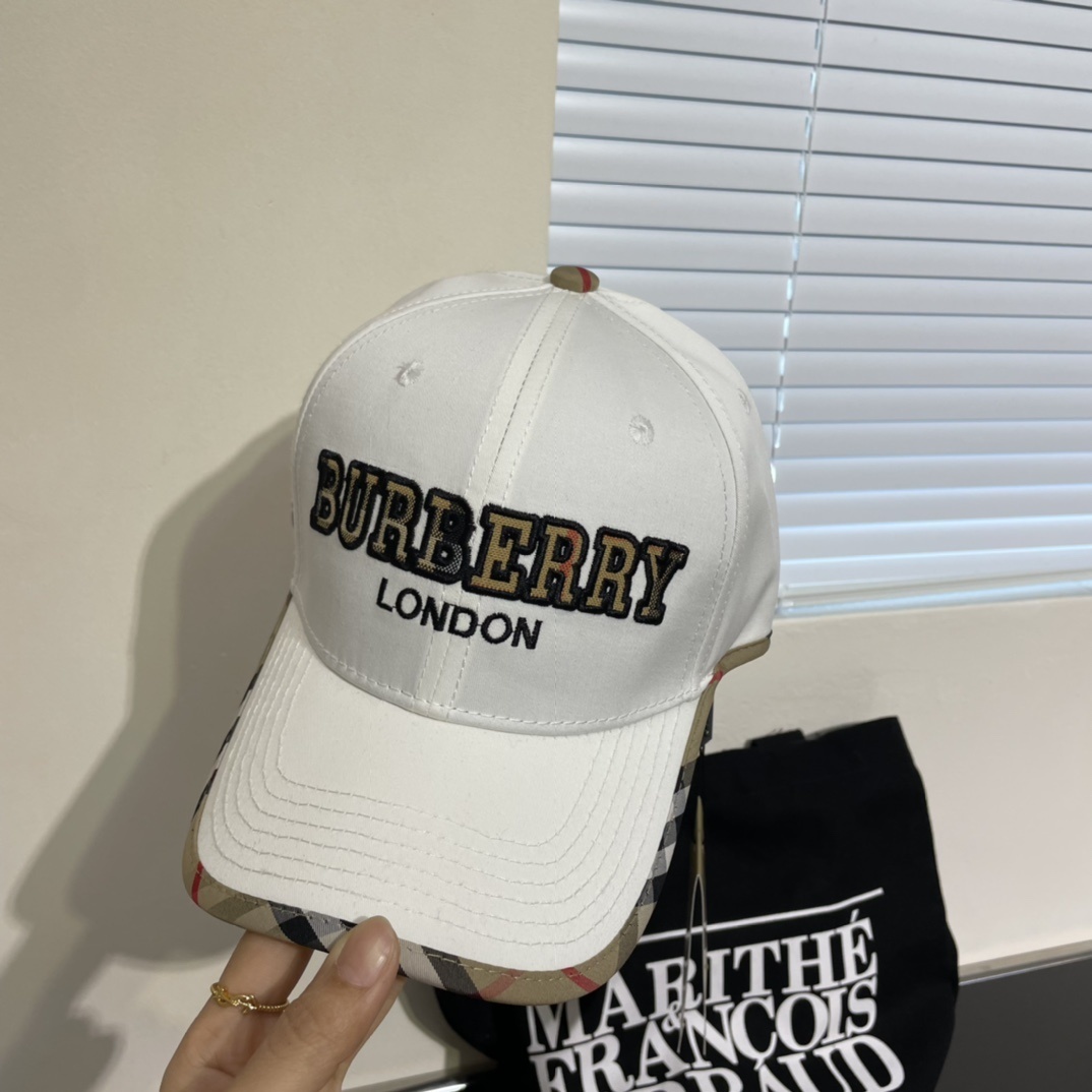 Burberry white cotton baseball cap with the Nova Check pattern on the underside of the brim and an embroidered logo on the front.