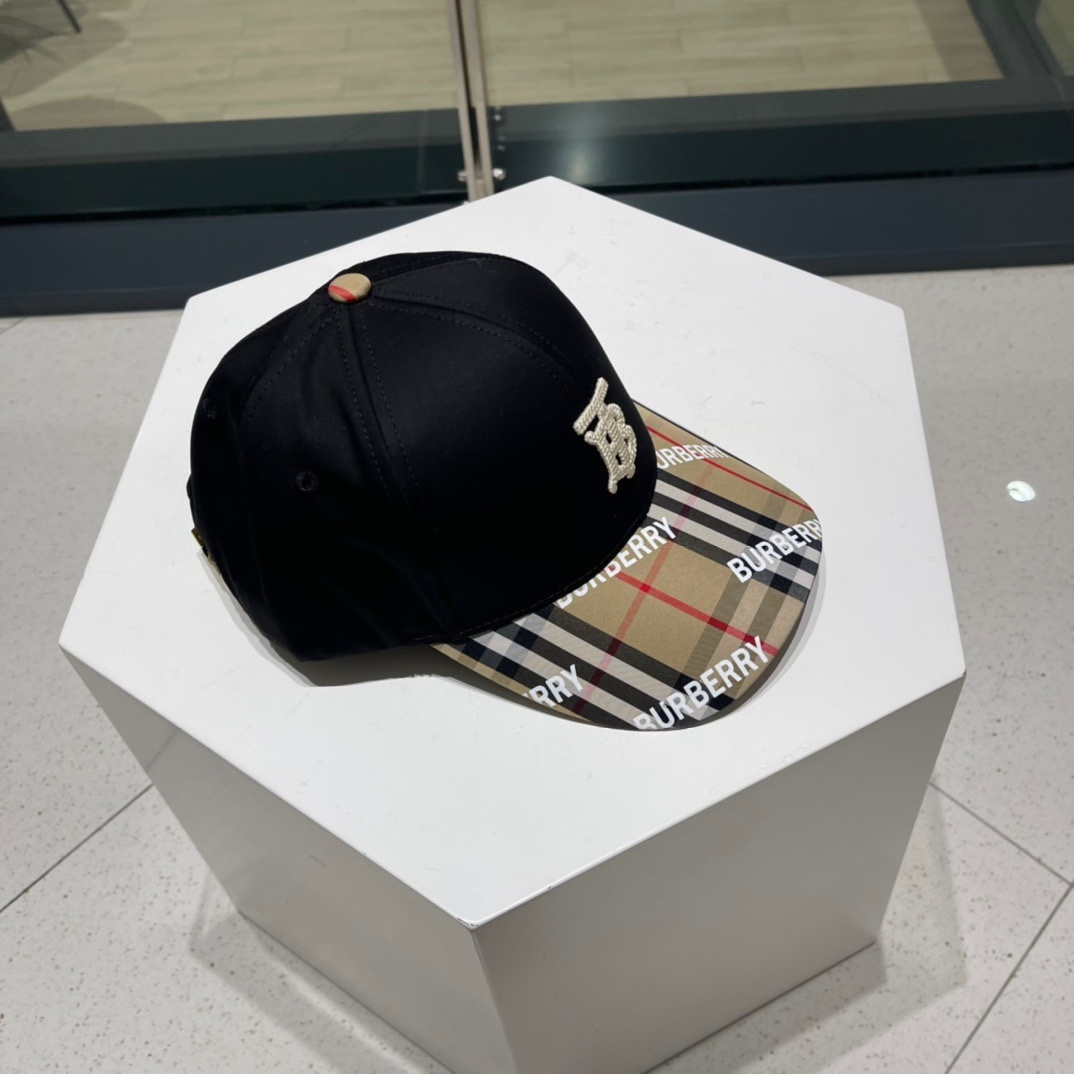 Burberry cotton baseball cap with the iconic Vintage Check pattern on the brim and an embroidered "B" or TB monogram logo on the front.