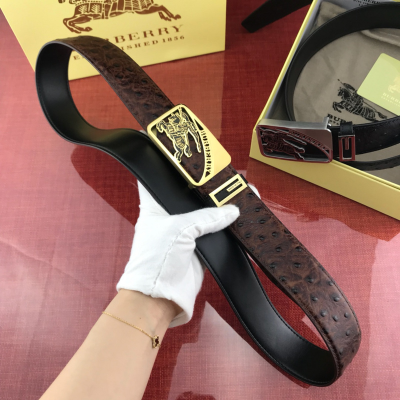 Burberry men's brown leather belt with an automatic buckle and a gold-tone lion logo.