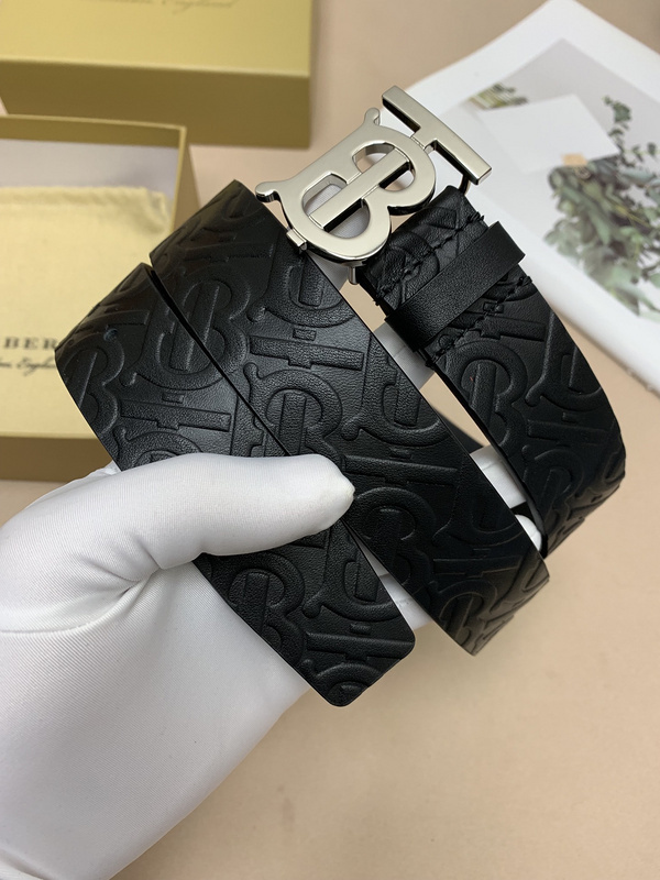 Burberry Monogram Motif embossed leather belt with a silver-tone TB monogram plaque buckle.