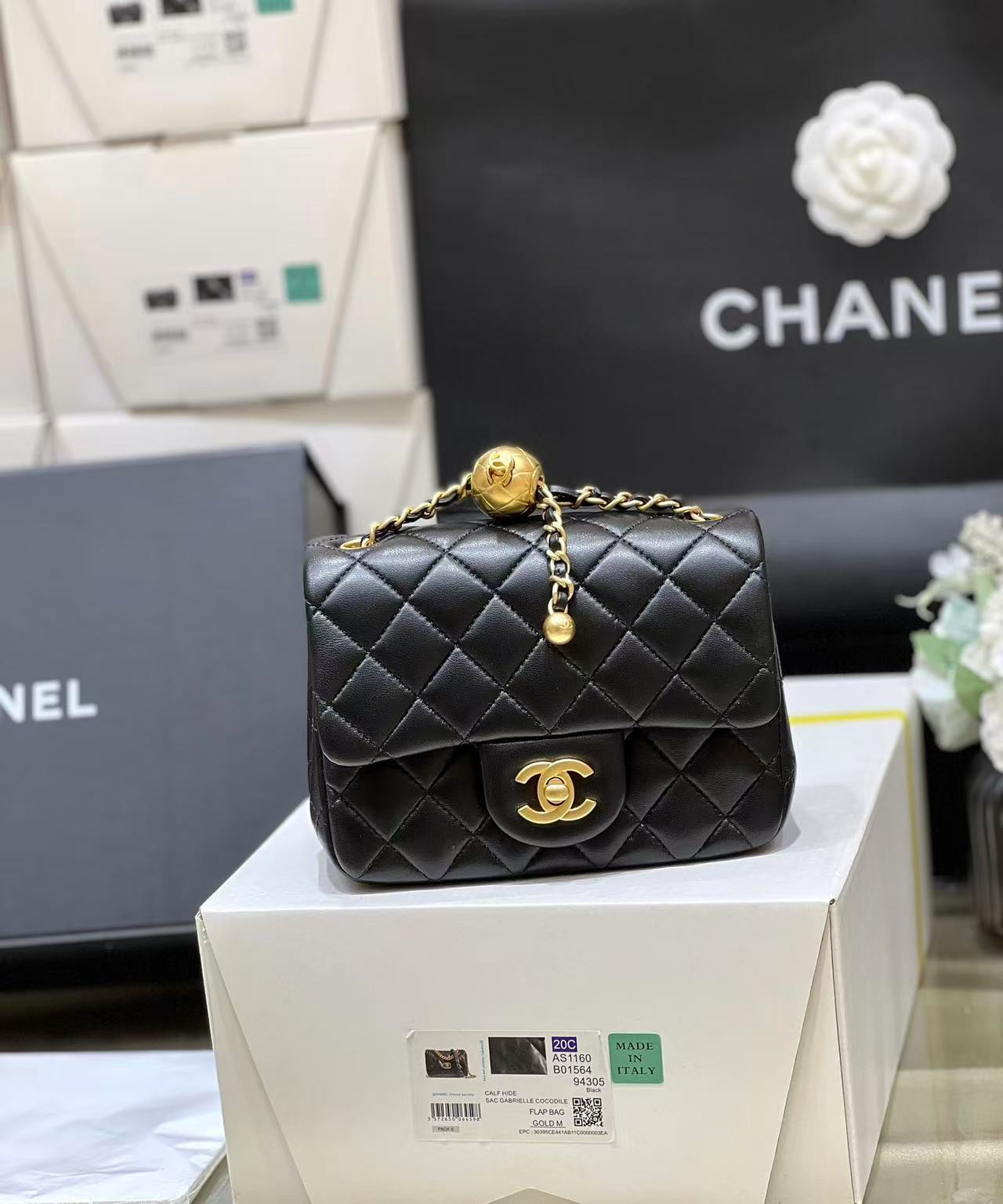 Chanel Mini Classic Handbag in black lambskin with gold-tone metal. 17cm