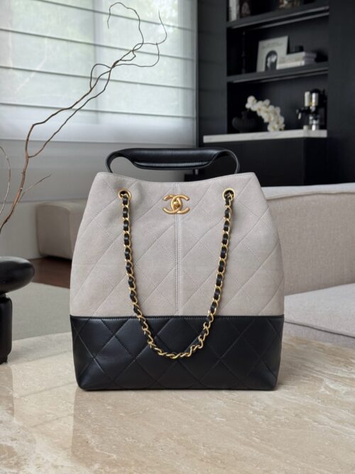 Chanel 25A hobo bag in a two-tone design featuring grey suede and black leather. Size 33x29x11cm