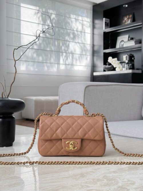 Chanel Mini Flap bag in a light brown or beige quilted caviar leather with a top handle and gold-tone hardware.  12×19.5×6.5cm