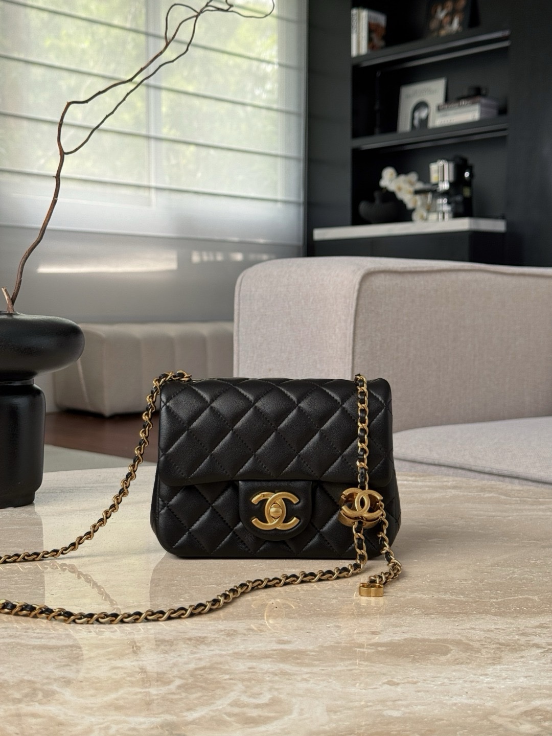 Chanel mini flap bag in black lambskin with gold-tone hardware.  13x18x7cm