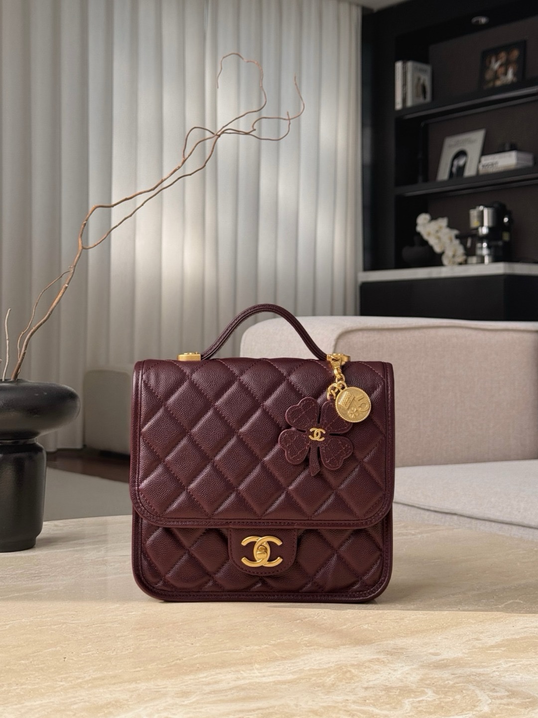 Chanel Grained Shiny Calfskin Backpack in a burgundy or deep red color.  Size 22×19.5x7cm