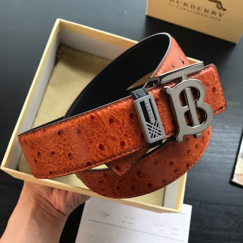 Burberry reversible leather belt with an ostrich leather texture and a B-shaped buckle.