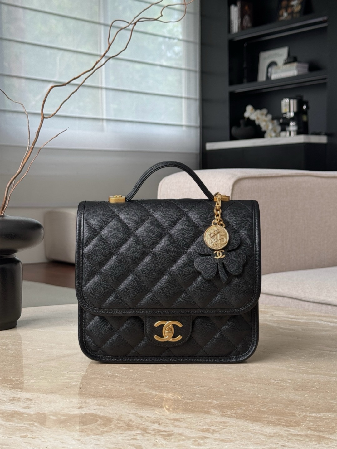 Chanel 25B four-leaf clover backpack in black grained shiny calfskin leather with gold-tone metal hardware.  22×19.5x7cm