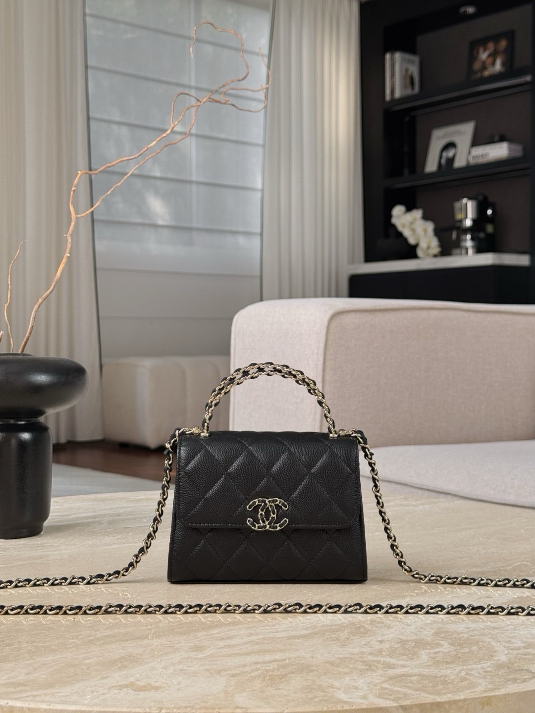 Chanel Top Handle Kelly clutch with chain in black caviar leather. Size 11.5×14.5×5.5cm