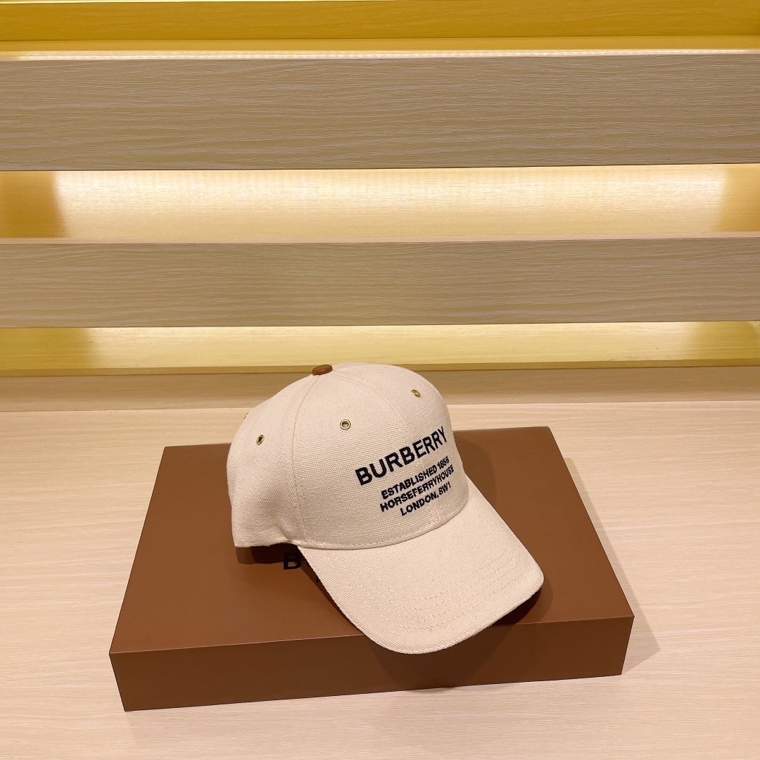 Burberry Horseferry Motif canvas baseball cap in natural/cream canvas with a brown button and black embroidered logo