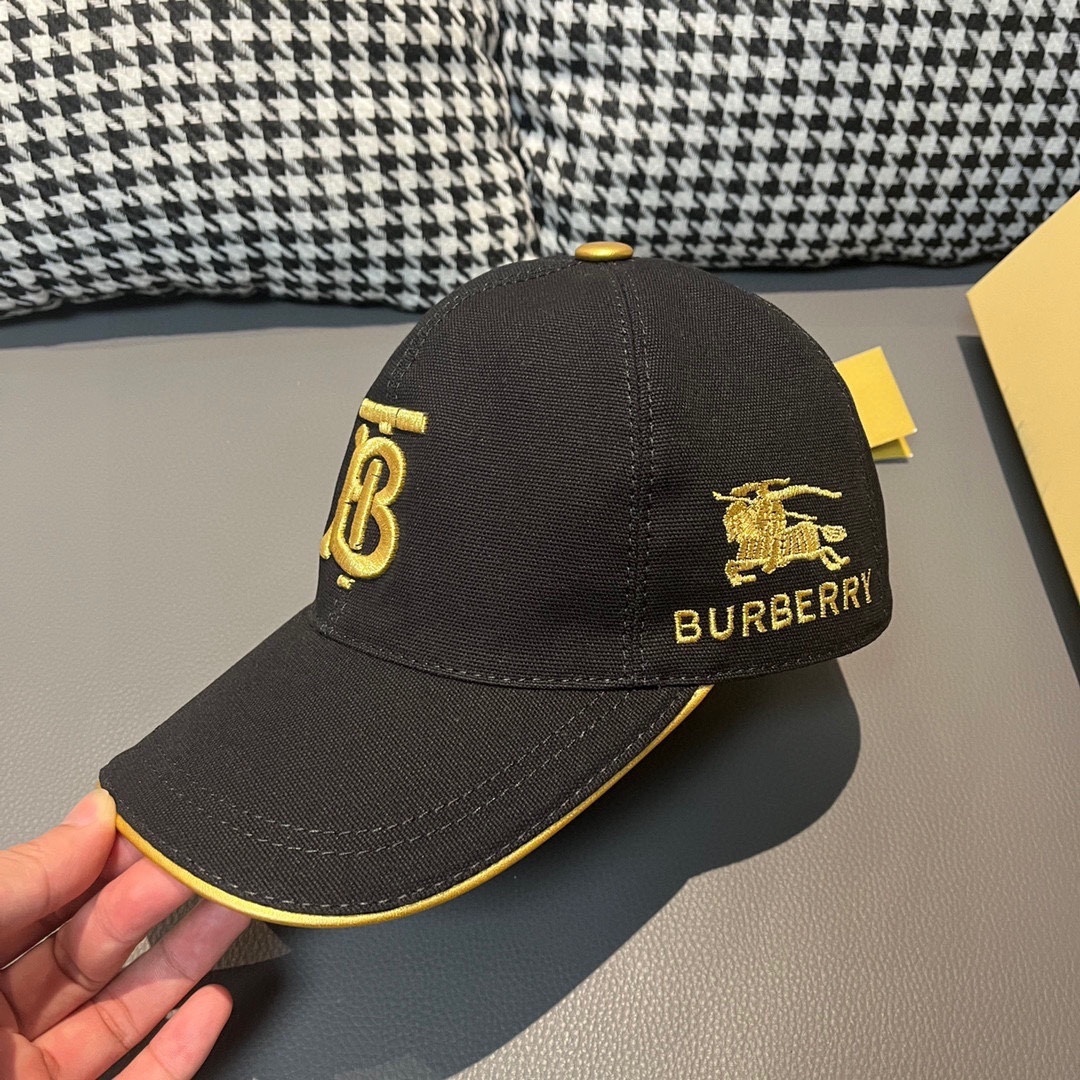 Burberry black baseball cap featuring the gold-embroidered Thomas Burberry Monogram logo
