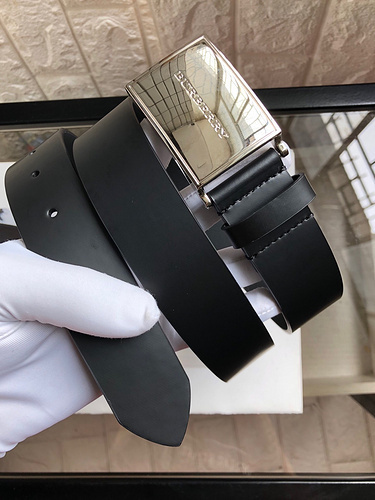 Burberry black leather belt with a silver-tone buckle, possibly a Coach men's reversible leather belt