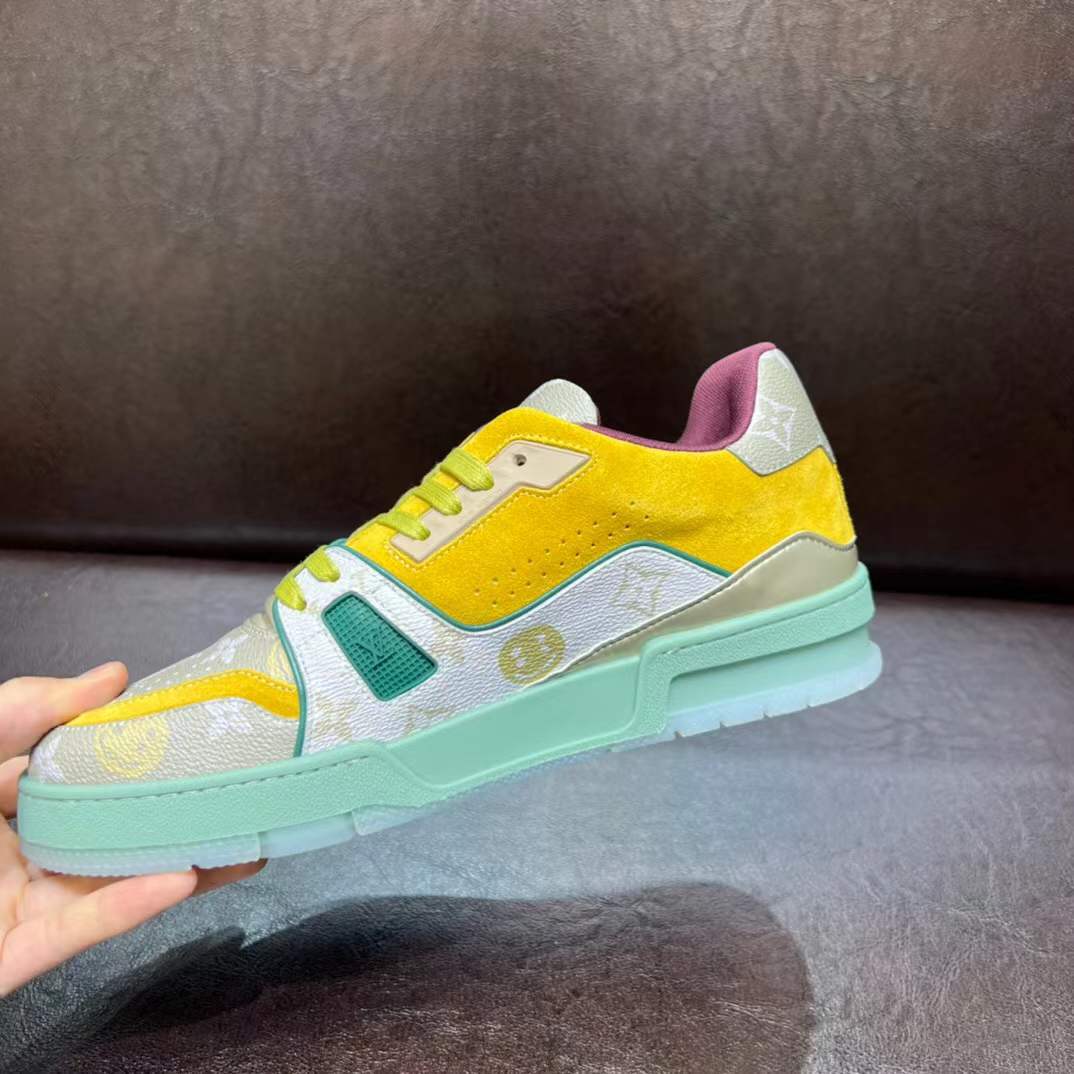 LV Trainer sneaker in a yellow, green, and white colorway with the signature Monogram pattern