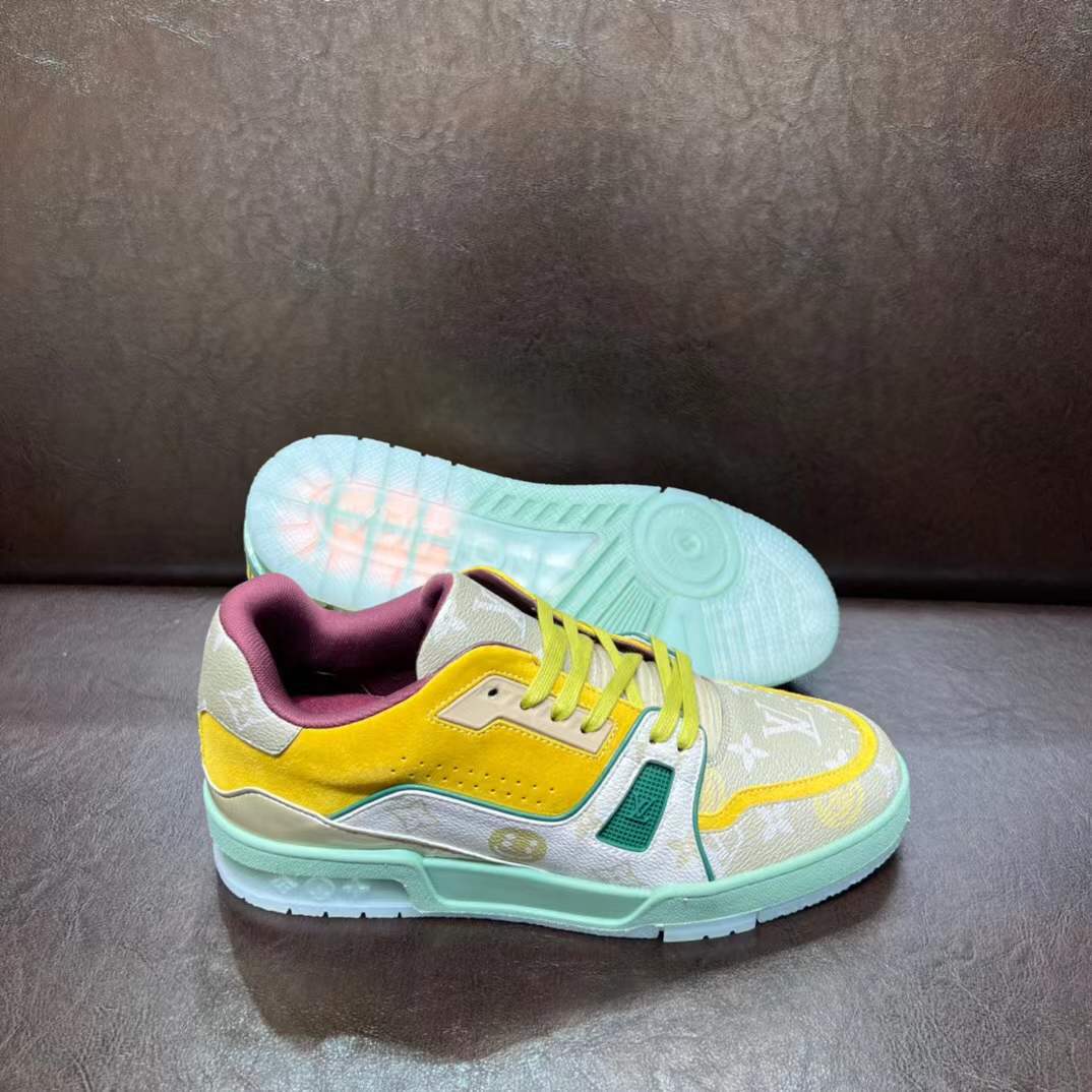 LV Trainer sneaker in a yellow, green, and white colorway with the signature Monogram pattern