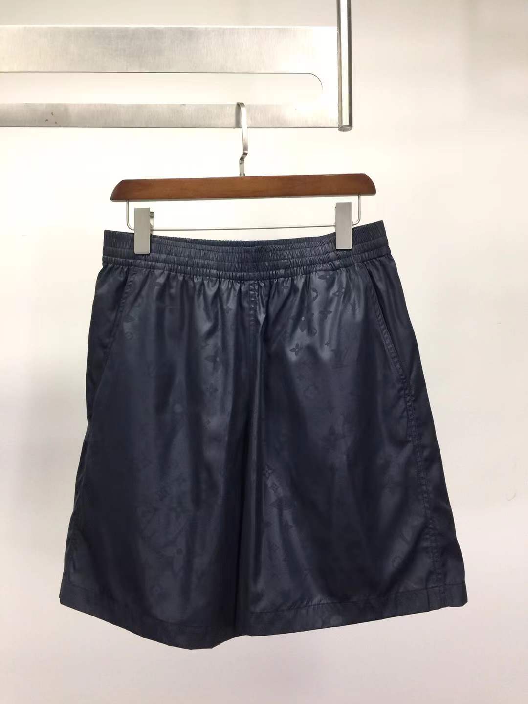 LV navy blue shorts possibly made from a synthetic or coated material.