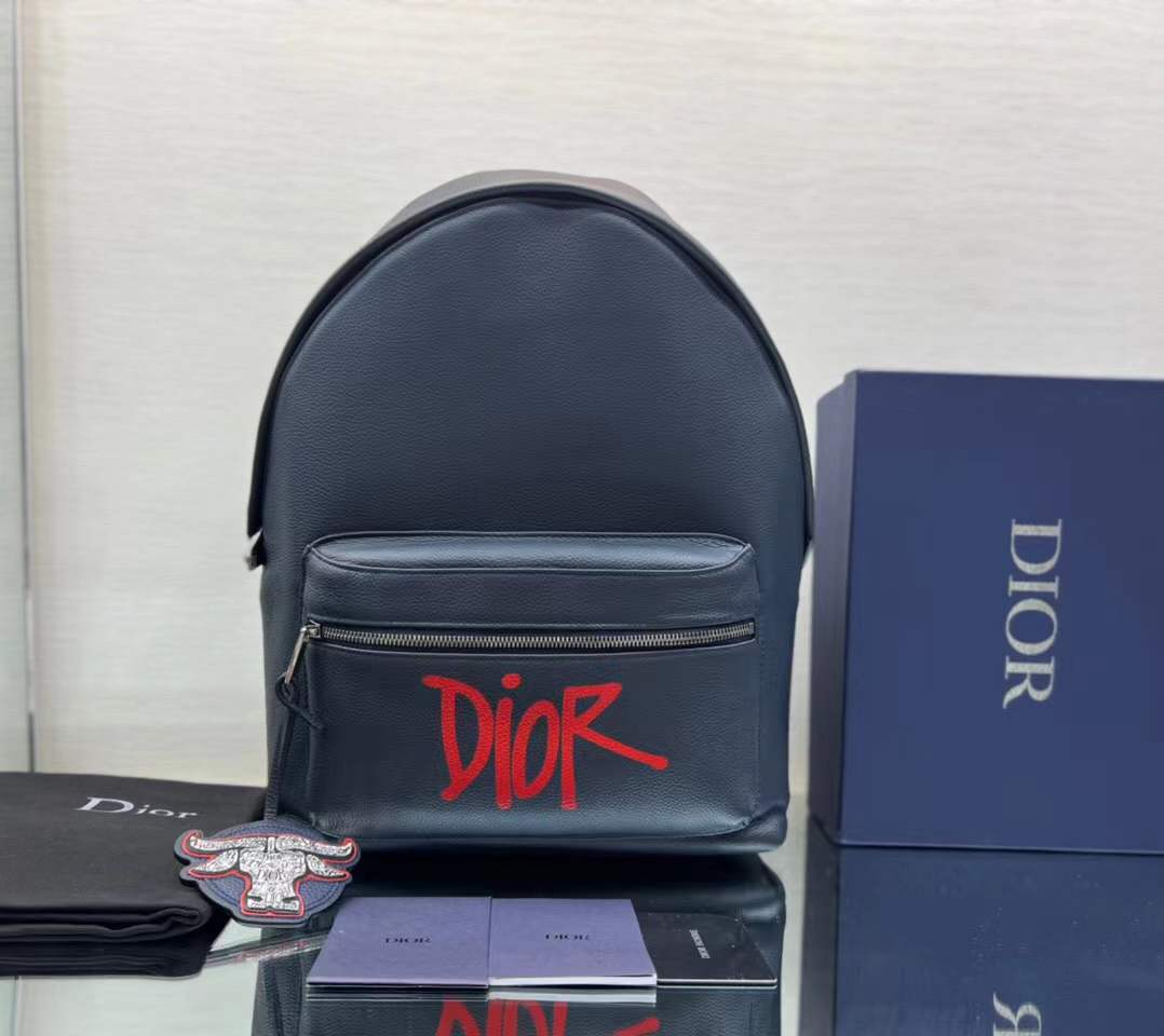 Dior and Shawn Rider backpack in navy blue grained calfskin with a red Dior signature