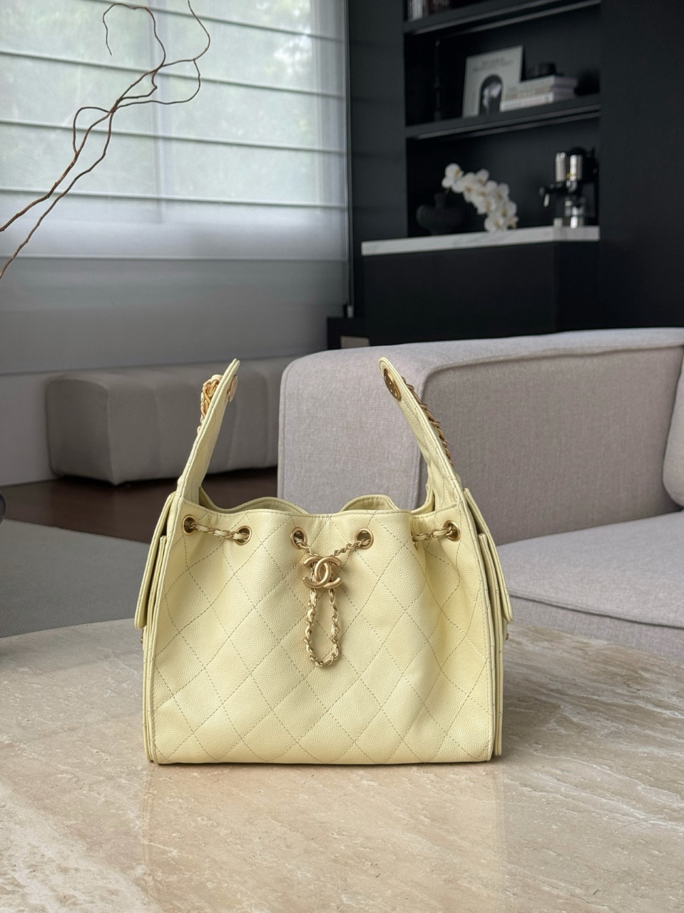 Chanel Code 10311 25S small hobo handbag in a light yellow or beige grained calfskin leather with gold-tone metal hardware Size 26x30x14cm