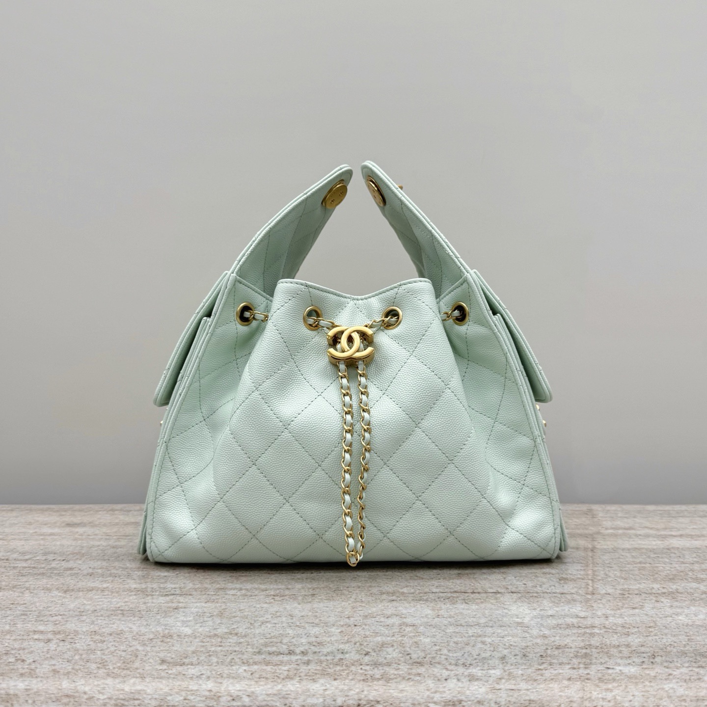 Chanel Code 10310 25S small hobo handbag in a light pastel or mint green metallic calfskin leather with gold-tone metal hardware Size 26x30x14cm