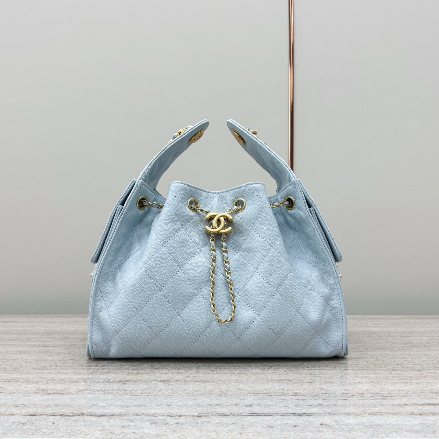 Chanel 25 Small Handbag hobo bag in light blue grained calfskin (or caviar leather) with gold-tone hardware.