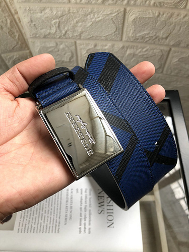 Burberry reversible check-pattern belt with a blue check pattern and an engraved silver-tone plaque buckle.