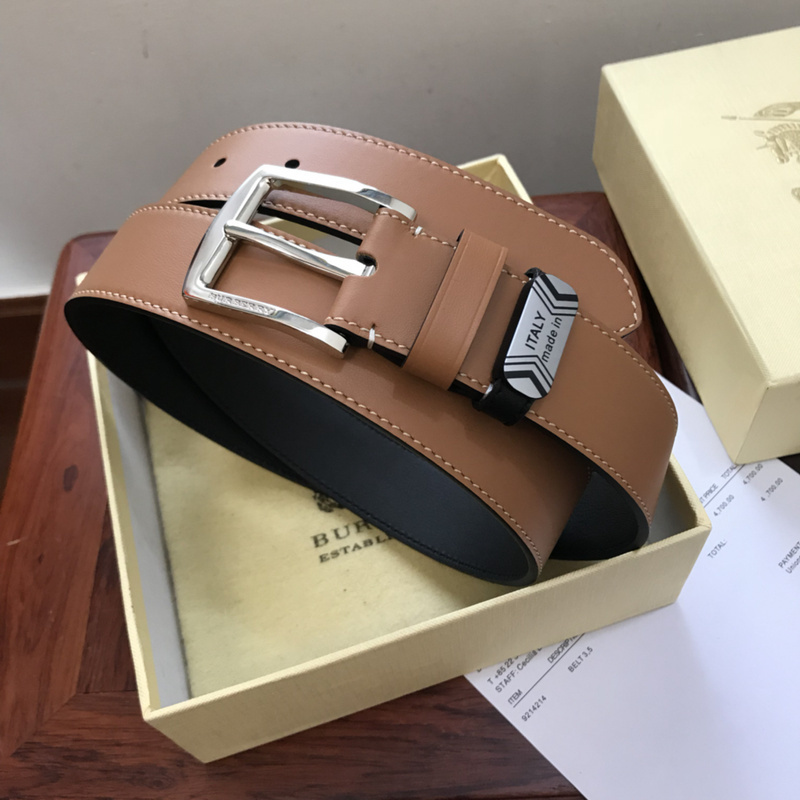 Burberry brown and black reversible leather belt with a silver-tone buckle and a small metal tag