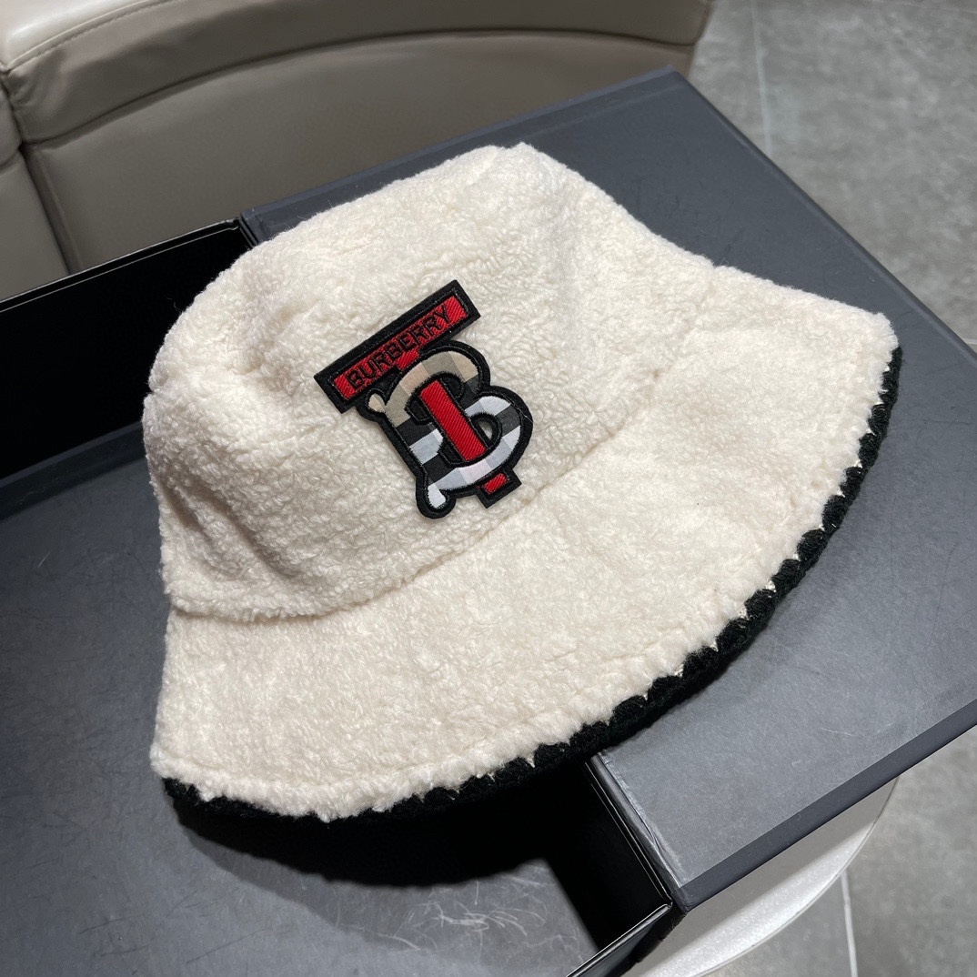Burberry TB Monogram fleece or sherpa bucket hat in white or off-white with a black rim