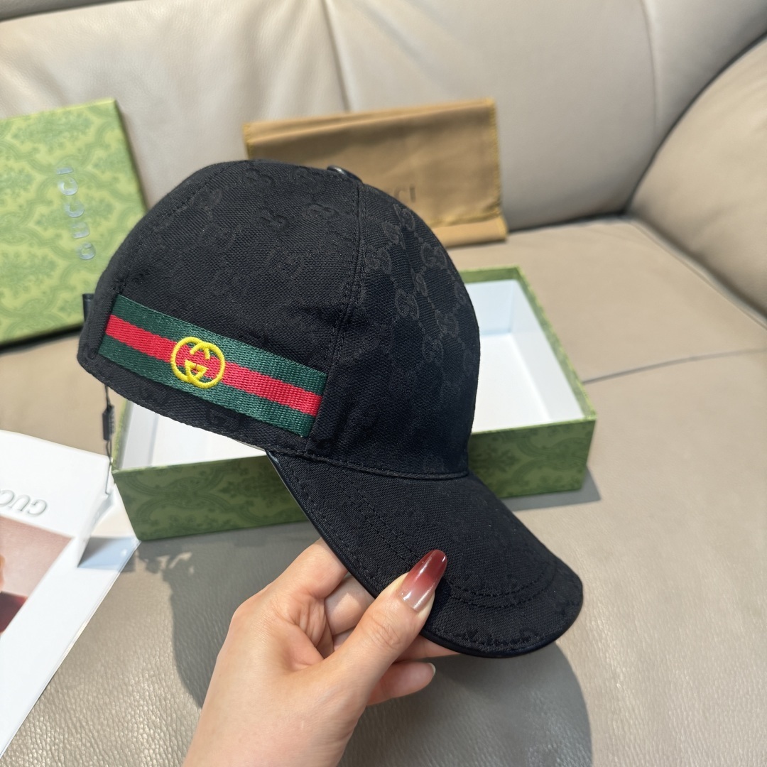 Gucci Original GG canvas baseball hat with a black leather trim and the signature green and red Web stripe detail.